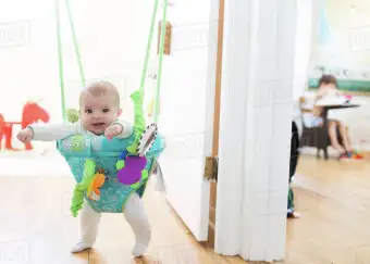 baby bouncer hanging from door